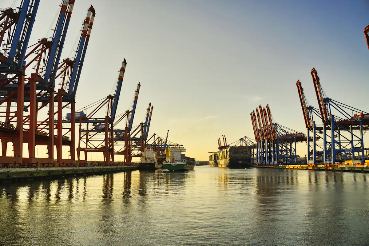 Container cranes at a port at sunset